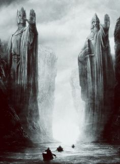 two large statues standing next to each other in the middle of a body of water