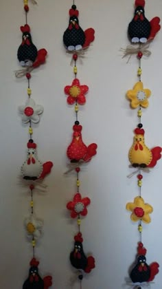 a bunch of birds hanging from the side of a wall with different designs on them