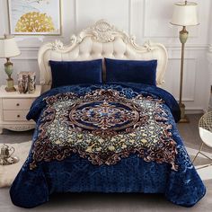 a bed with blue and gold comforters in a room