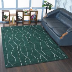 a green rug with white lines on it in a living room next to a couch