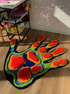 a multicolored hand rug on the floor in a child's room