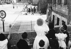 a black and white photo of people holding up signs