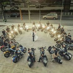 a group of people riding motorcycles on top of a parking lot next to each other