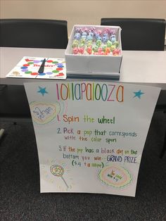 a table with a sign that says, i spin the wheel and some sort of candy