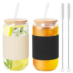 two mason jars filled with lemonade and limeade next to each other on a white background