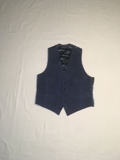 "vintage 1970s men's waistcoat vest smokey blue corduroy front braided black buttons 4 pocket front blue acetate feel backing corduroy feels cotton, might have a blend of small amount of synthetic double v front hem straight hem back back waist sash good vintage condition, light wear, bottom button is decorative, doesn't lay properly buttoned labeled 42 Reg, see below measures, lying flat, shoulder-12\" chest-21\" waist-18 1/2\" hem-19\" length-27\"    All sales final, no returns/exchanges. Please feel free to contact us with any questions you may have about an item prior to purchase and we will gladly answer them." Formal Blue Vest With Buttons, Fitted Blue Vest With Buttons, Fitted Retro Vest With Button Closure, Retro Fitted Vest With Button Closure, Fitted Vintage Blue Vest, Blue Fitted Vintage Vest, Blue Fitted Vest For Fall, Navy Fitted Vest For Fall, Navy Fitted Winter Vest