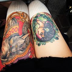 two women with tattoos on their legs sitting next to each other