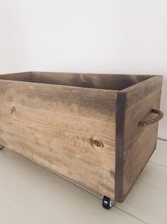 a wooden box sitting on top of a white floor