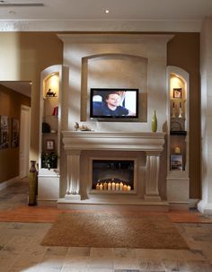 a living room with a fire place and a flat screen tv mounted on the wall