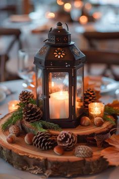 a lit candle is sitting on top of a tree slice with pine cones and other decorations