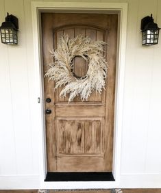 a wooden door with a wreath on it