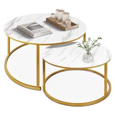 two tables with white marble top and gold metal legs, one has a plant on it