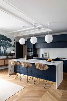 a kitchen with two bar stools next to an island