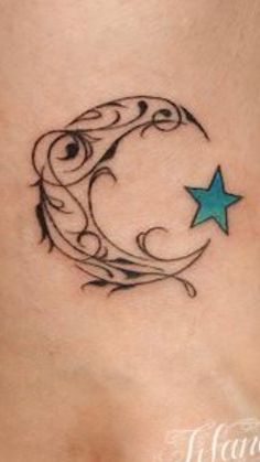 a woman's stomach with a crescent and star tattoo on it