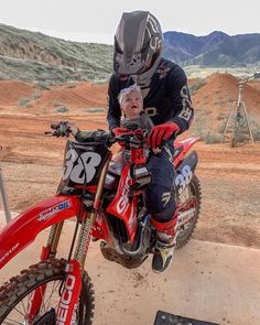 a man riding on the back of a dirt bike