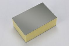 a gray and yellow box sitting on top of a white table