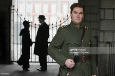 a man in uniform is standing outside