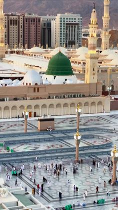 an aerial view of the grand mosque in the middle of the city with many people around it