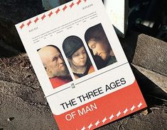 the three ages of man movie poster sitting on top of a piece of wood next to a fire hydrant