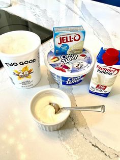 yogurt and other ingredients are sitting on a counter top next to an ice cream container