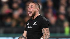 a rugby player with his mouth open in front of an audience at a sporting event