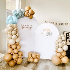 balloons are arranged in the shape of letters that spell out baby is growing on top of a table