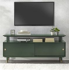 an entertainment center with a flat screen tv mounted above it