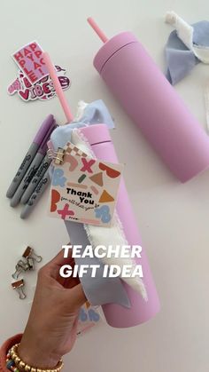 a person is holding a pink cup with a straw in it and the words teacher gift idea written on it