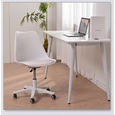 a white desk with a laptop on it and a plant in the corner next to it