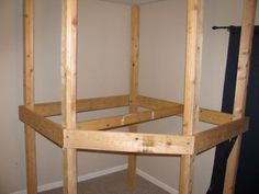 an unfinished room with wood framing on the wall and carpeted flooring in front of it