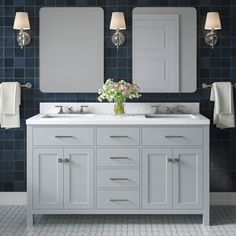 a bathroom with two sinks and mirrors in it