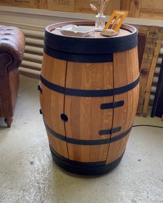 a wooden barrel table with an umbrella on top