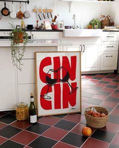 a kitchen with red tile flooring and a poster on the counter top that says sun