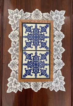 a wooden frame with blue and white designs on it