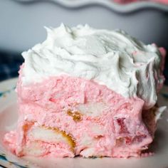 a piece of cake with white frosting on a plate next to a pie dish