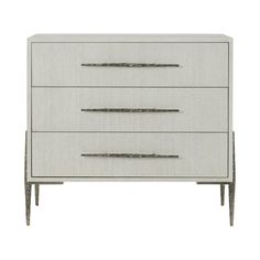 a white dresser with three drawers and two silver handles