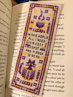 an open book with a cross stitch pattern on it