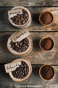 three bowls filled with coffee beans next to each other on top of a wooden table