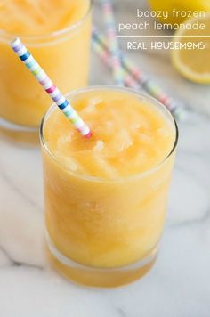 two glasses filled with orange juice on top of a table