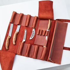 a knife and some knives in a leather case