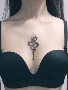 a woman with a snake tattoo on her chest