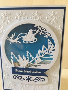 a christmas card with a santa sleigh and reindeer on it, in the middle of snowflakes