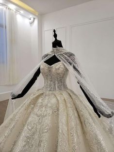 a wedding dress on display in a room