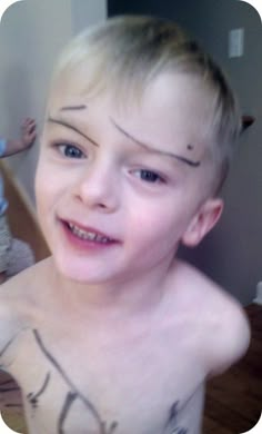 a young boy with tattoos on his chest