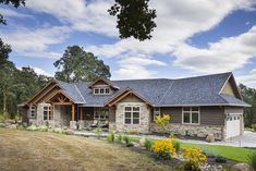 a large house with stone and wood accents