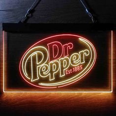 a neon sign hanging from the side of a wooden wall with a dr pepper logo on it