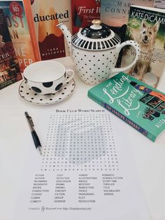 a table topped with books and a tea pot