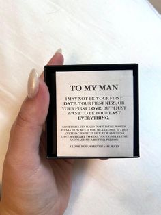 a person holding up a small box with a poem on it that says to my man