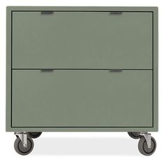 a green cabinet with two drawers on wheels