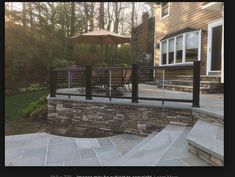 a patio with stone steps and an umbrella